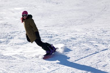 Pas de la Casa, Andorra, December 03 2019: Snowboarder on the ski slope of Grandvalira, the largest ski resort in the Pyrenees and southern Europe.