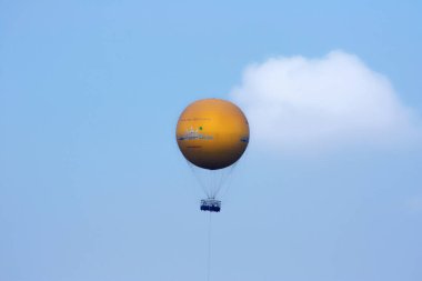 Siem Reap, Cambodia - April 12 2009: Hot air balloon filled with tourists contemplating from the sky the UNESCO World Heritage Site of Angkor.