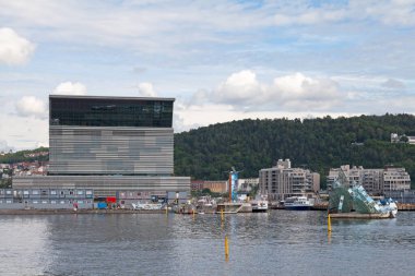 Oslo, Norway - June 26 2019: The Munch Museum at Bjorvika on the waterfront, next to the Oslo Opera House and She Lies.