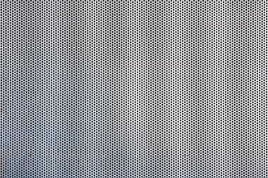 Full frame close-up on a seamless hexagon perforated metal grill pattern.