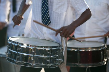 Close-up on two Snare drummers playing during the carnival of the Grand Boucan.