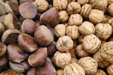 Close-up on a stack of chestnuts and walnuts on a merchant's stall.