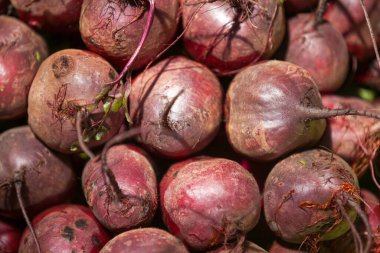 Full frame close up on a stack of beetroots for sale on a market stall.