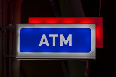 ATM sign in Athens indicating that an automated teller machine is located beneath it.