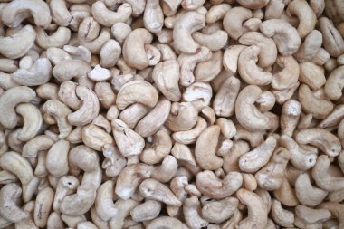 Close-up on a stack of cashew nuts for sale on a market stall.