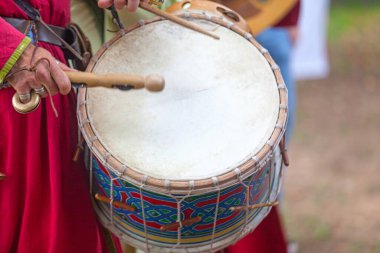 A medieval minstrel playing drum during the annual Medievales festival. In autumn, in many medieval towns in France, festivals are held where people can disguise in knights, monks, farmers... of the medieval period.