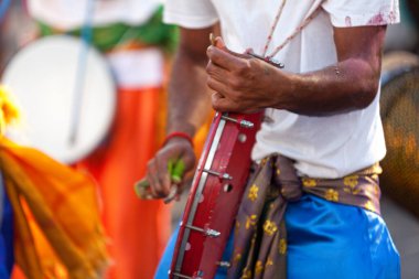 Musician playing with frame drum during the Grand Boucan carnival.