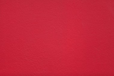 Full frame close-up on a concrete wall painted in red