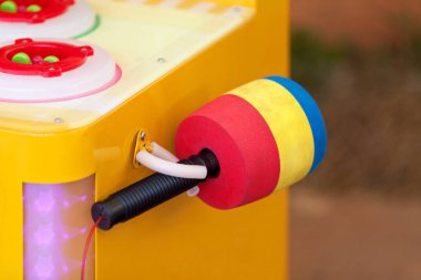 Hammer on the top of a Whac-A-Mole arcade game in a carnival.