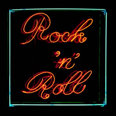 Close-up on a neon light shaped into a square with written inside 