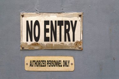 Two signs on a door with written 