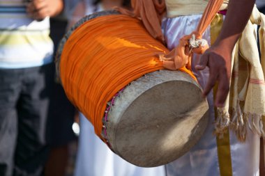 Percussionist playing with a dhol during the carnival of the Grand Boucan.