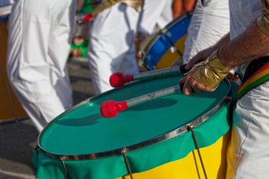 Close-up on a percussionist playing with a drum during the carnival of the Grand Boucan.