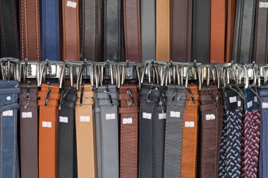 Close-up on a stack of leather belts for sale on a market stall in Athens, Greece.
