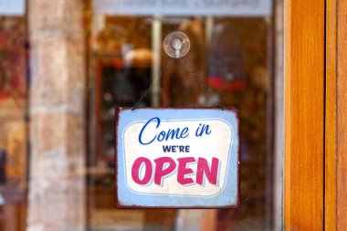 Close-up on an english open sign saying 