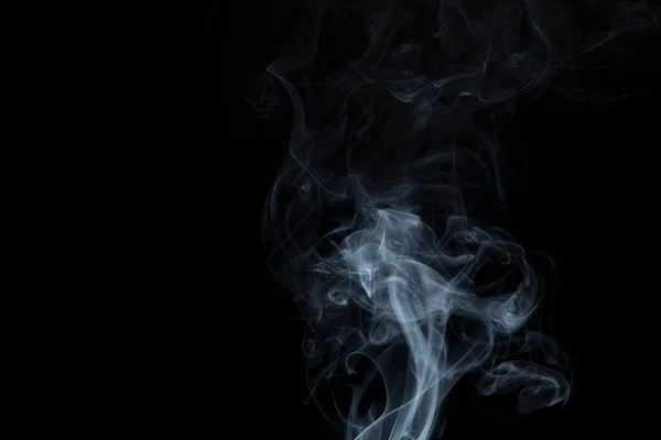 Abstract white smoke swirling on a black background.