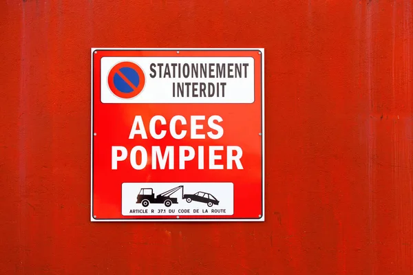 Warning Sign stating in french Stationnement interdit, Acces pompier, meaning in english Parking forbidden, firemen access.