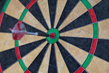 Close-up on a Dart in the bull's eye.