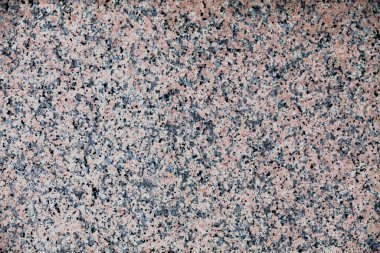Full frame close up on a pink granite slate.