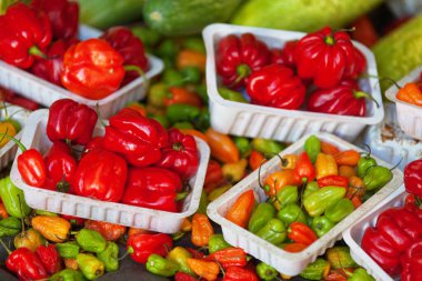 Close-up on a stack of Piment cabri (same family as Habanero) for sale on a market stall.