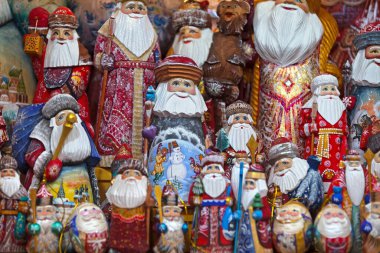 Santa Claus toys for sale in the retail display of a gift shop.