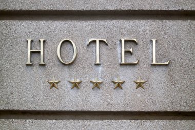 Close-up on a brass 5 stars hotel sign. clipart