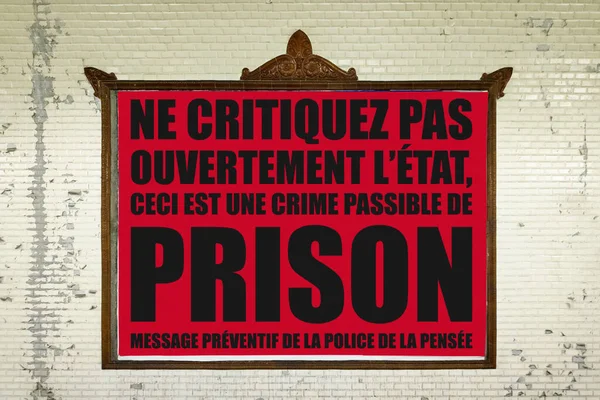 Close-up on a billboard in a Parisian Metro station with a message in French meaning in English \
