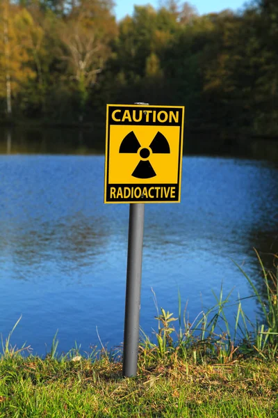 Radioactive warning sign on a lakeside.