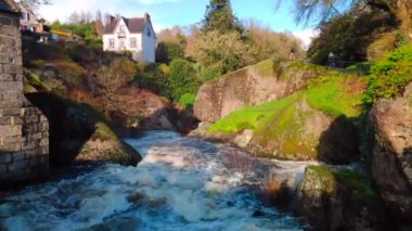 The water of the Silver River in Huelgoat flowing at high speed between the rocks after stormy days.