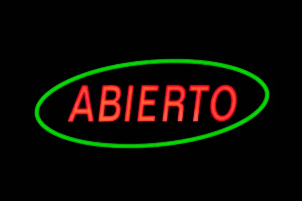 スペイン語で オープン を意味するスペイン語で形作られた別の赤いネオンと緑の楕円形のネオン — ストック写真