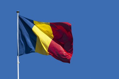 Close-up on the flag of Romania waving atop of its pole clipart