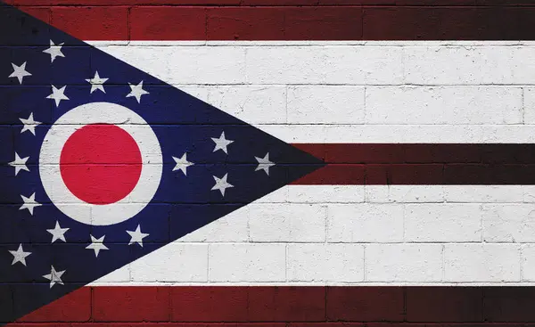 Flag of Ohio painted on a cinder block wall.