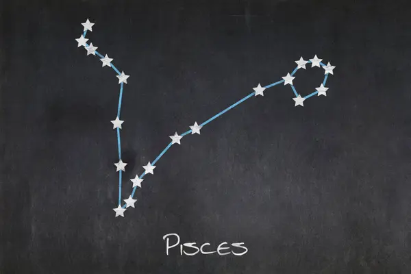 Blackboard with the Pisces constellation drawn in the middle.