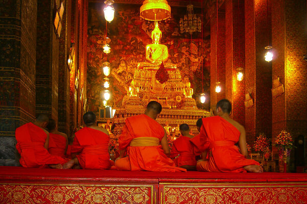 Bangkok, Thailand - July 10 2006: Young buddhist monks praying at Wat Pho in Bangkok.
