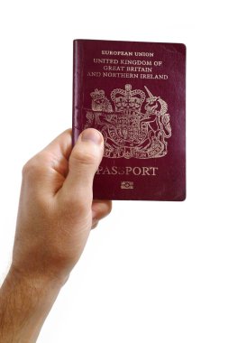 Beyaz arka planda İngiliz pasaportu tutan bir adamın yakın plan fotoğrafı..