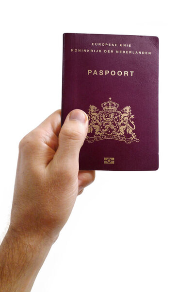 Close-up on a man's hand holding a passport from Netherlands against a white background.