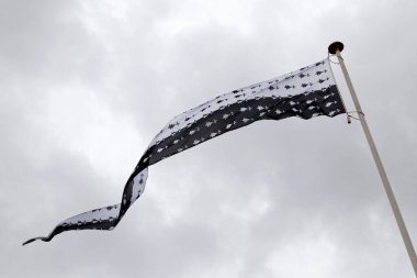 Flag of the Dukes of Brittany waving on the curtain walls of the Castle of the Dukes of Brittany.