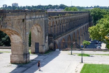 Montpellier, France - June 09 2018: The aqueduc des Arceaux, whose real name is the aqueduc Saint-Clement, is an aqueduct built in the eighteenth century by the engineer Henri Pitot de Launay. It is one of the most beautiful monuments in the city. clipart