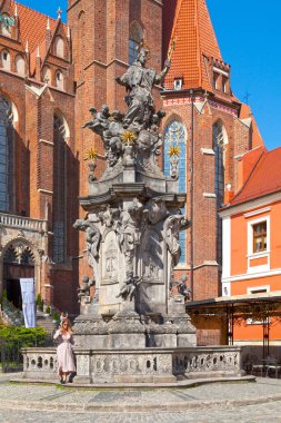 Wroclaw, Poland - June 05 2019: Statue of St. John Nepomuk created by Jan Jiri Urbansky in 1732 opposite the Collegiate Church of the Holy Cross and St. Bartholomew on Cathedral Island. clipart