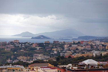 Aerial view of Naples in Italy with behind the islands of Ischia and Procida. clipart