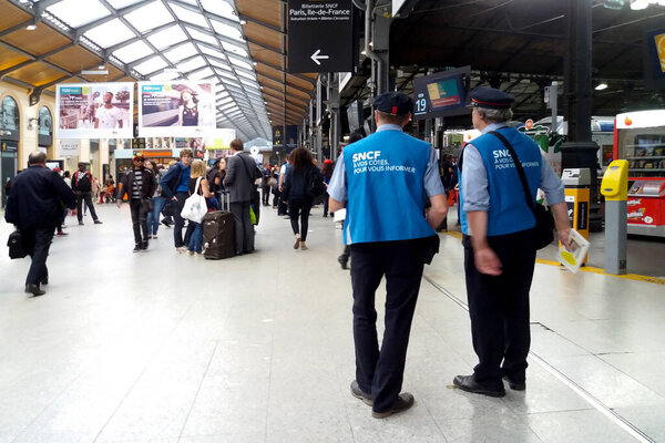 Paris, France - September 07 2017: Two SNCF employees in the Gare Saint-Lazare waiting to assist any travellers in need for help.