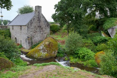 The moulin du Chaos (Water Mill of the boulders) at the entrance of the Riviere d'Argent (Silver river) running through the woods of Huelgoat in Brittany, France. clipart