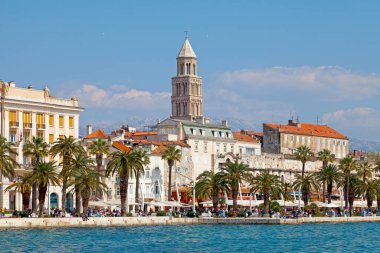Split, Croatia - April 16 2019: Bell tower of Saint Domnius Cathedral by the sea with the Mosor mountains behind. clipart