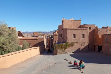 Ouarzazate, Morocco - January 30 2019: Berber women chating in Rue de la Mosquee (English: Street of the Mosque) inside of the Kasbah Taourirt. clipart