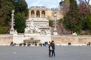 Rome, Italy - March 17 2018: Fountain of the Goddess of Rome at the Piazza del Popolo with the terrace of the Pincio behind. clipart