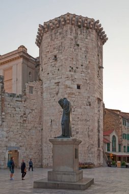 Split, Croatia - April 16 2019: Statue of Marko Maruli In front of the Venetian Tower.  clipart