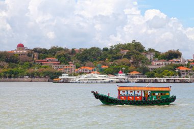 Xiamen, China - August 14 2018: Boat passing in front of Gulangyu Island. clipart