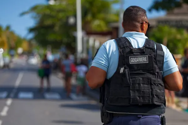 stock image Saint-Gilles les bains, La Reunion - June 25 2017: Gendarme in bulletproof vest patrolling during the carnival of the Grand Boucan.