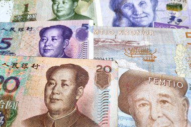 Close-up on a stack of Chinese Remninbi and Swedish Krona. clipart