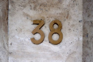 Close-up on a Number 38 on a marble wall. clipart